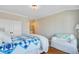 Bedroom featuring hardwood floors, white trim, a plush white chair, and a double door closet at 1500 Bower Ln, Johns Island, SC 29455