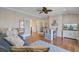 Bonus room featuring hardwood floors, a comfortable sofa, TV and an open doorway to a staircase at 1500 Bower Ln, Johns Island, SC 29455