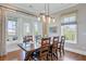 Inviting dining room with views to outdoor patio and custom lighting fixture over wooden table at 1500 Bower Ln, Johns Island, SC 29455