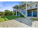 Back exterior showing a large patio, lush lawn, and multilevel decks on this beautiful coastal home at 1500 Bower Ln, Johns Island, SC 29455