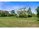 Sprawling lawn surrounds this beautiful home with a metal roof and inviting front porch at 1500 Bower Ln, Johns Island, SC 29455