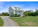 Beautiful home with lush landscaping, a metal roof and an inviting front porch at 1500 Bower Ln, Johns Island, SC 29455