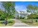 Charming two-story home features a manicured lawn, driveway, and inviting front porch at 1500 Bower Ln, Johns Island, SC 29455