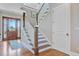 Light-filled entryway showcases wooden floors, staircase, and elegant front door at 1500 Bower Ln, Johns Island, SC 29455