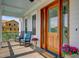 Relaxing front porch with rocking chairs and beautiful wood double-doors at 1500 Bower Ln, Johns Island, SC 29455