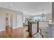 Bright second floor hallway with hardwood floors, lovely pendant light, and views to a living space at 1500 Bower Ln, Johns Island, SC 29455