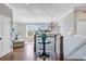 Bright second floor hallway with hardwood floors, a striking pendant light, and stairway access at 1500 Bower Ln, Johns Island, SC 29455