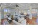 Open-concept living area with coffered ceilings, hardwood floors, and access to a patio with beautiful outdoor views at 1500 Bower Ln, Johns Island, SC 29455