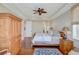 Lovely main bedroom with hardwood floors, ceiling fan, and a large armoire, offering both comfort and style at 1500 Bower Ln, Johns Island, SC 29455