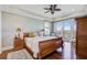 Comfortable main bedroom suite with wood floors, a ceiling fan and a private balcony that overlooks a scenic view at 1500 Bower Ln, Johns Island, SC 29455