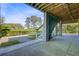 Covered outdoor space with concrete flooring and steps leading to an upper patio and views of the lawn at 1500 Bower Ln, Johns Island, SC 29455
