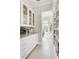 Butler's pantry with granite countertops, wine rack and custom shelving leading to the laundry room at 1500 Bower Ln, Johns Island, SC 29455