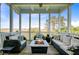 Inviting screened porch with comfortable seating and outdoor fireplace, perfect for enjoying the scenic view at 1500 Bower Ln, Johns Island, SC 29455