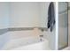 Bathroom featuring a white tub with tiled trim, a shower, and gray towels at 1500 Bower Ln, Johns Island, SC 29455