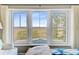 Bedroom window view overlooking tranquil landscape with water and trees at 1500 Bower Ln, Johns Island, SC 29455