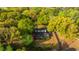 Aerial view of the home surrounded by lush trees with a screened-in porch and established yard at 1518 Southwick Dr, Johns Island, SC 29455