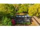 Aerial view of the home with an established yard, screened-in porch, and detached carport with storage at 1518 Southwick Dr, Johns Island, SC 29455
