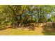 Backyard featuring a swing set, mature trees offering shade, and a storage shed at 1518 Southwick Dr, Johns Island, SC 29455