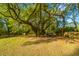 Spacious backyard featuring a large tree with a treehouse and a swing at 1518 Southwick Dr, Johns Island, SC 29455