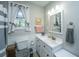 Well-lit bathroom featuring a white vanity, framed mirror, and neutral wall paint at 1518 Southwick Dr, Johns Island, SC 29455