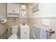 Well-organized bathroom with a toilet, sink, towel rack, and wall storage at 1518 Southwick Dr, Johns Island, SC 29455
