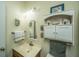Modest bathroom with decorative wall art, wood vanity, and classic light fixture at 1518 Southwick Dr, Johns Island, SC 29455