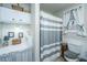 Well-lit bathroom features a striped shower curtain, an American flag view, and functional cabinets at 1518 Southwick Dr, Johns Island, SC 29455