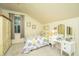 Bright bedroom features a vanity with mirrored dressing table, soft carpet, and sunny windows at 1518 Southwick Dr, Johns Island, SC 29455