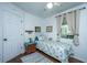 Bright bedroom featuring a twin bed, a bedside table with a lamp, and a window with curtains at 1518 Southwick Dr, Johns Island, SC 29455