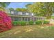 Charming two-story home with a screened-in porch and beautifully landscaped front yard with colorful flowers at 1518 Southwick Dr, Johns Island, SC 29455