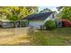 Charming exterior of a two-story home featuring a lattice fence, lush landscaping, and a screened porch at 1518 Southwick Dr, Johns Island, SC 29455