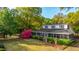 Charming two-story home with a screened-in porch and beautifully landscaped front yard with colorful flowers at 1518 Southwick Dr, Johns Island, SC 29455