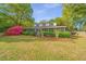 Charming two-story home with a screened-in porch and beautifully landscaped front yard with colorful flowers at 1518 Southwick Dr, Johns Island, SC 29455