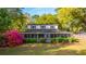 Two-story home with a screened porch, blooming bougainvillea, and well-maintained landscaping at 1518 Southwick Dr, Johns Island, SC 29455