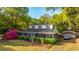 Charming two-story home featuring a screened porch, lush landscaping, and a detached garage at 1518 Southwick Dr, Johns Island, SC 29455