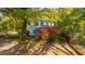 Two-story home framed by mature trees and blooming azaleas in a lush landscaped yard at 1518 Southwick Dr, Johns Island, SC 29455