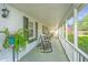 Spacious front porch with comfortable seating and views of the well-maintained yard at 1518 Southwick Dr, Johns Island, SC 29455