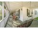 Covered front porch with porch swings and comfortable seating at 1518 Southwick Dr, Johns Island, SC 29455