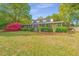 Charming two-story home with a screened porch, an American flag, and colorful azalea bushes at 1518 Southwick Dr, Johns Island, SC 29455