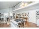 Bright open-concept kitchen and dining area feature vaulted ceilings, white cabinetry, and farmhouse-style decor at 1518 Southwick Dr, Johns Island, SC 29455