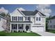 Inviting two-story home featuring a classic design, gray siding, dark shutters, and a well-manicured lawn at 152 Seaton St, Summerville, SC 29486