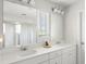 Bright bathroom with dual sinks, white cabinets, quartz counters and walk in shower at 153 Lucca Dr, Summerville, SC 29486
