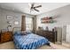 Comfortable bedroom with blue bedspread, ceiling fan, shelves, and decorative accents throughout at 153 Lucca Dr, Summerville, SC 29486