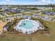 Aerial view of a community pool with lounge chairs and seating, palm trees, and convenient parking for residents at 153 Lucca Dr, Summerville, SC 29486