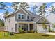 Beautiful two-story home with well-maintained lawn, complemented by mature trees and landscaping at 153 Lucca Dr, Summerville, SC 29486
