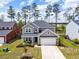 Charming two-story home featuring a welcoming front porch and a two-car garage, complemented by lush landscaping at 153 Lucca Dr, Summerville, SC 29486