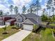 Two-story home with a two-car garage, front porch, modern gray siding, and well-maintained lawn and landscape at 153 Lucca Dr, Summerville, SC 29486
