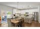 Bright and modern kitchen with white cabinets, stainless steel appliances, and a breakfast bar island at 153 Lucca Dr, Summerville, SC 29486