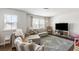 Cozy living room with comfortable seating, a large window, and a modern entertainment center with TV at 153 Lucca Dr, Summerville, SC 29486