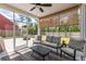 Cozy screened porch with comfortable seating, ceiling fan, and a view of the backyard at 153 Lucca Dr, Summerville, SC 29486